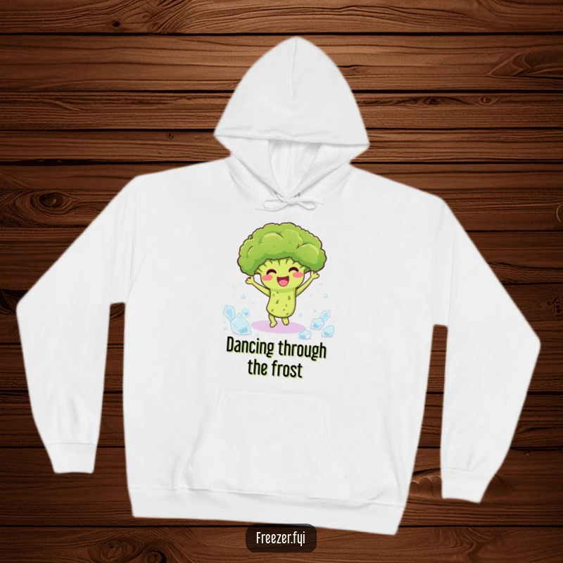 Funny hoodie depicting a happy broccoli character dancing among ice crystals, offering warmth and cheerful humor.
